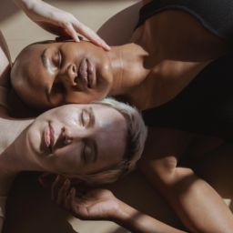 Two women laying head to head with their eyes closed