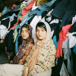 Women in front of clothes